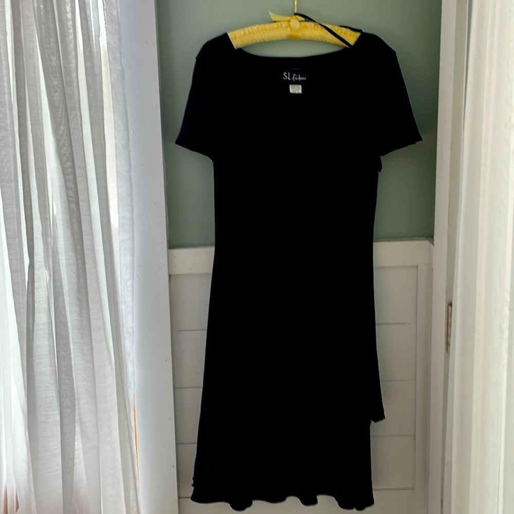 Black crepe tiered cocktail dress with detailed beading on hemline.